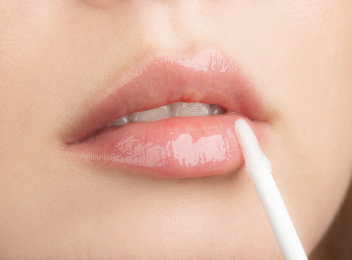 Woman Apply Moisturizing Lip Gloss